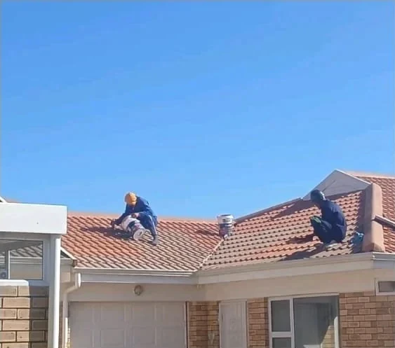 Team working on a tiled roof
